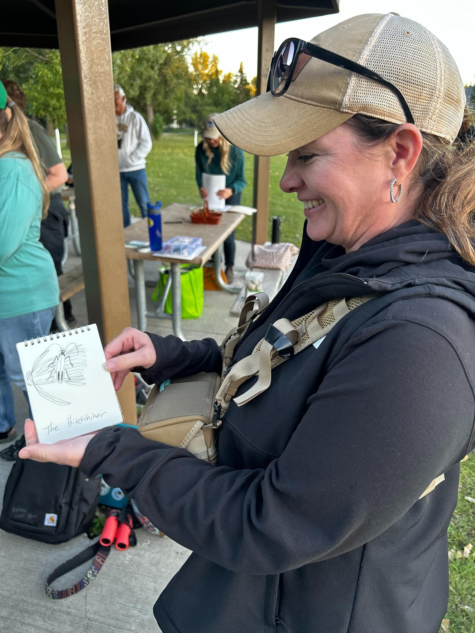 woman holding up drawing