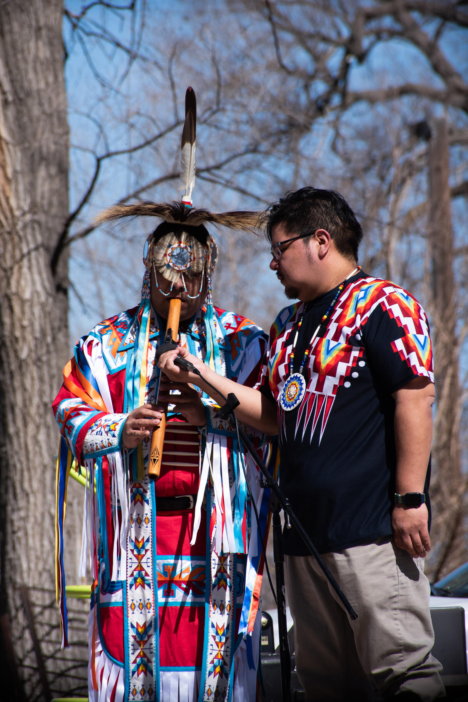 Gentry St. Cyr played the flute, and Lewis “Bleu” St. Cyr (right) spoke at the event with Many Moccasins Dance Troupe