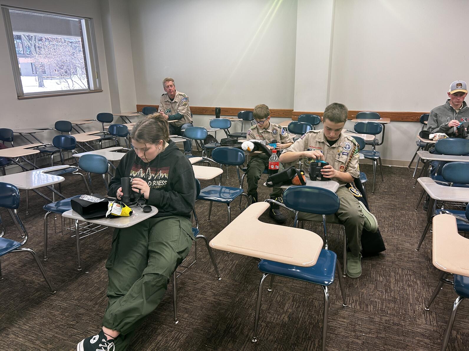 students cleaning binoculars